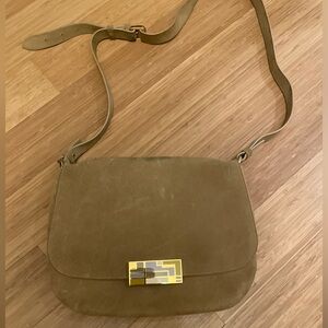 French designer saddle bag, 100% tan suede with gold art deco embellishment.